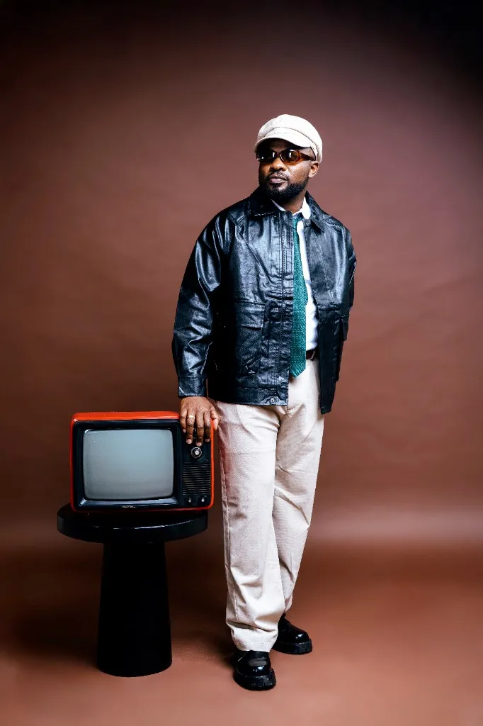 Ally Fresh full-length studio portrait resting a hand on a vintage red TV