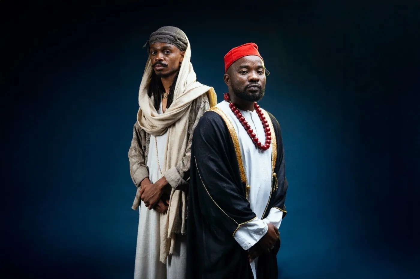 Ally Fresh and collaborator in traditional attire, side-by-side studio portrait